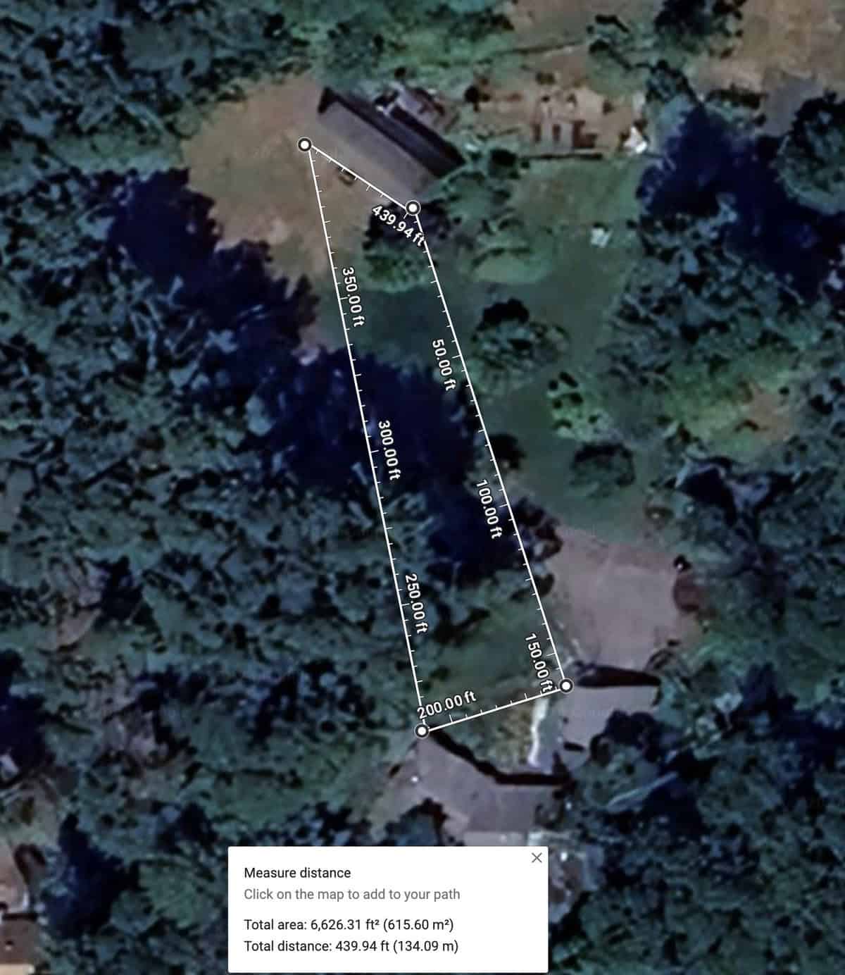 A satellite image of a plot of land surrounded by dense trees. The plot is outlined with white lines, showing dimensions: 439.94 ft, 100.00 ft, 250.00 ft, 150.00 ft, 500.00 ft, and 359.00 ft—ideal for planning a garden design! Measurement data indicates an area of 6,626.31